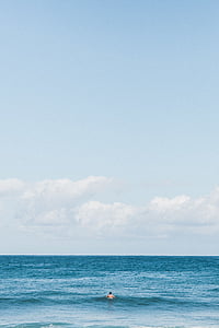 man bathing on sea at daytime thumbnail