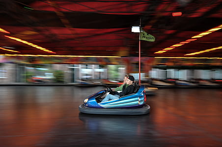 panning photography of two men riding bump car thumbnail