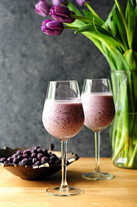 milkshake in clear wine glasses on brown wooden surface thumbnail