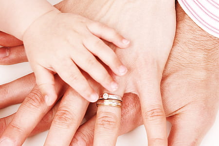 father, mother, and baby holding each other thumbnail