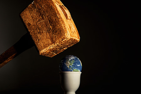 earth on top of white cup under brown mallet illustration thumbnail