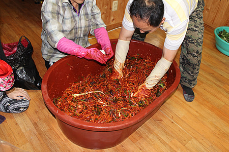 twp people mixing vegetables on red tub thumbnail