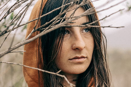 shallow focus photography of woman in brown hood thumbnail
