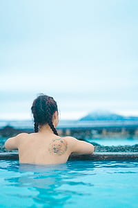 woman on pool looking at mountains thumbnail