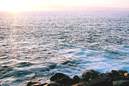 photo of body of water under cloudy sky thumbnail