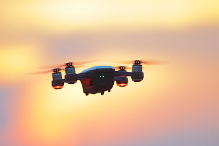 Black and Gray Dji Mavic Pro Drone Hovering at Golden Hour thumbnail