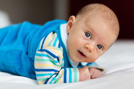 baby wearing blue and yellow footie pajama thumbnail