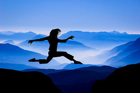 silhouette of person jumping under mountain background thumbnail
