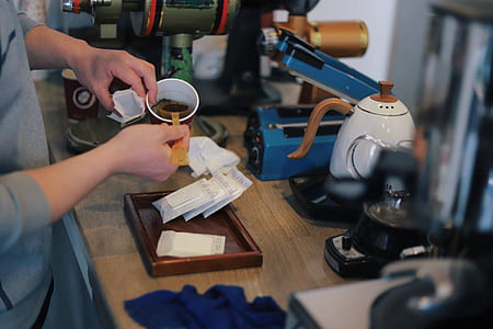 person scooping coffee while standing thumbnail