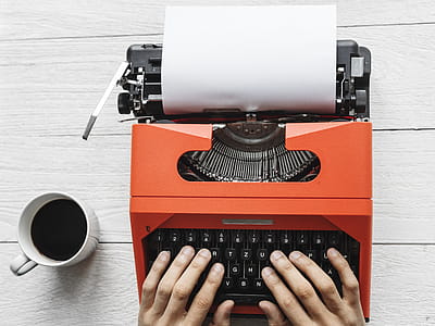 Flat-lay Photo of Hands Typing on a Typewriter thumbnail