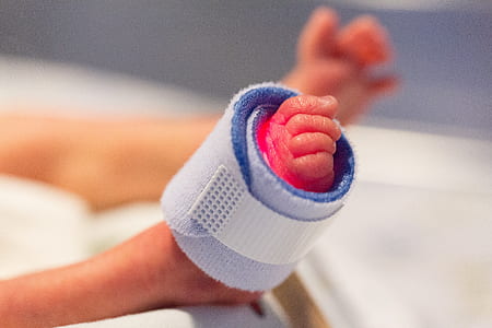infant with white foot strap thumbnail