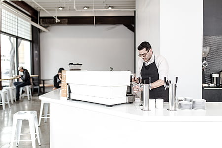 man wearing black apron while baking some pastries thumbnail