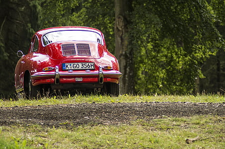 red coupe on green grass thumbnail