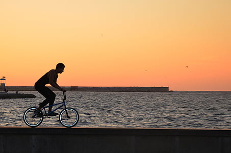 man riding on BMX bike at sea side thumbnail