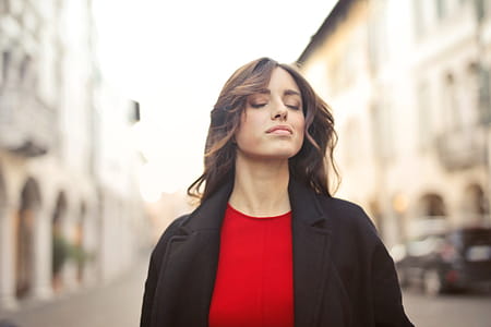 Selective Focus On Woman In Black Blazer And Red Shirt Walking On Street thumbnail