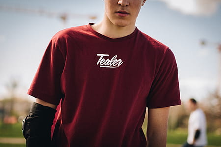 closeup photo of man wearing red tealer-printed t-shirt thumbnail