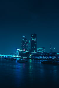 body of water across high-rise buildings at night thumbnail