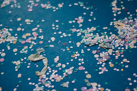 multicolored ornaments on teal surface thumbnail