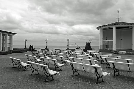 grayscale photograph of benches near pagoda thumbnail