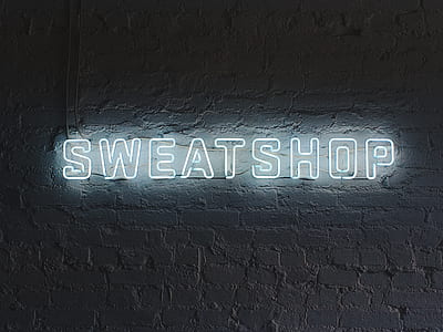 white Sweatshop neon signage on wall thumbnail