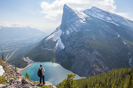 man standing on top of the mountain during daytime thumbnail