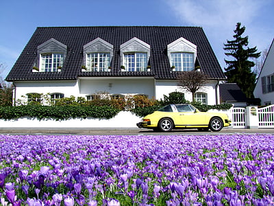 yellow car parked in front of white house during daytime thumbnail