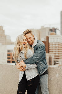 man hugging woman beside wall thumbnail