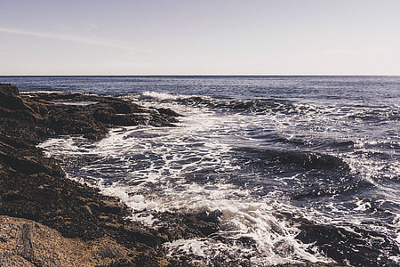 blue sea near rocks thumbnail