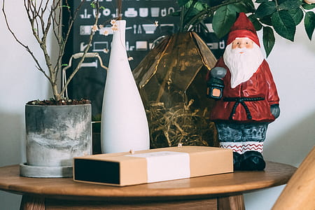 Santa Claus figurine on table beside box thumbnail