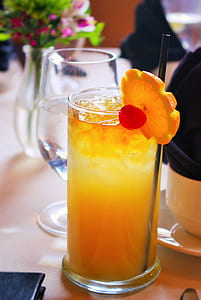 clear drinking glass filled with orange juice thumbnail