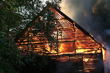 burning house near green leafed tree at daytime thumbnail