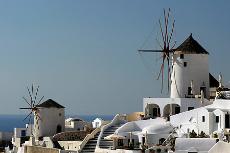 white painted buildings with windmill under blue sky at daytime thumbnail