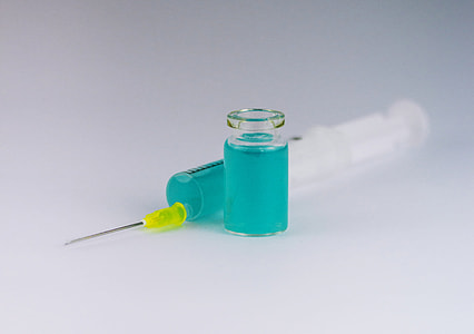 syringe near vial filled with liquid thumbnail
