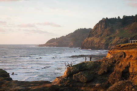 seashore mountain during day time thumbnail