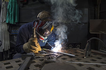 man wearing mask welding gray tool thumbnail
