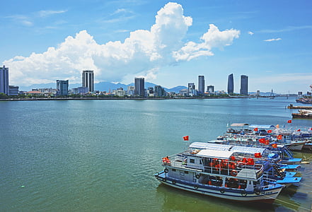 boats docked near high-rise buildings thumbnail