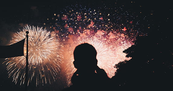 silhouette of person watching fireworks display thumbnail