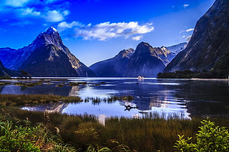 landmark photo of lake between mountains during daytime thumbnail