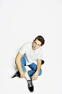 man wearing white button-up shirt sitting on white ground thumbnail