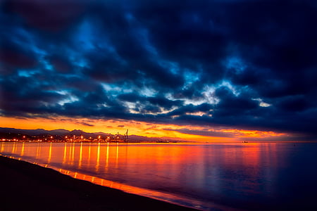 body of water under cloudy sky thumbnail