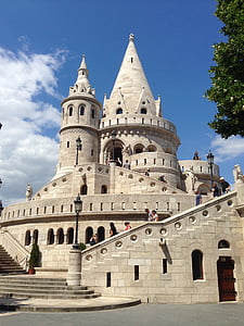 people walking on gray concrete structure with tower during daytime thumbnail