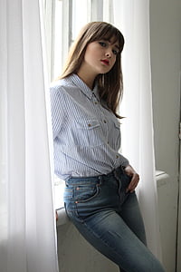 woman beside window curtain thumbnail