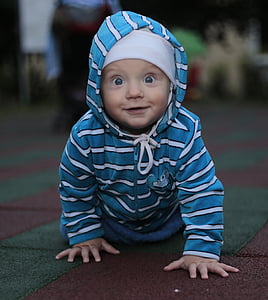 shallow focus photography of baby in blue and white striped jacket thumbnail