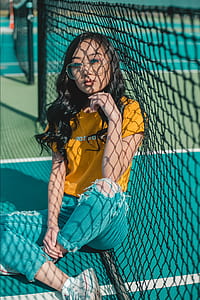 woman sitting beside a net thumbnail