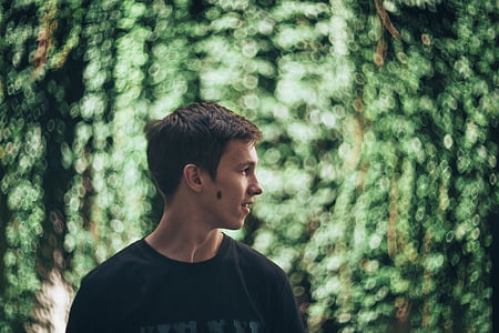 selective focus photography of man with green background thumbnail