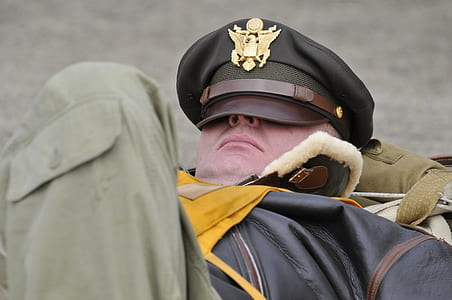 man lying covered his face with black cap thumbnail