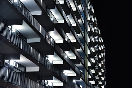 gray concrete building at night thumbnail