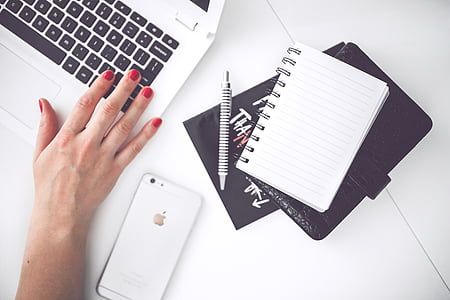 silver iPhone 6 near notebook, pen, wallet and white and black laptop computer thumbnail
