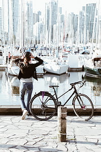 woman standing on deck during day time thumbnail
