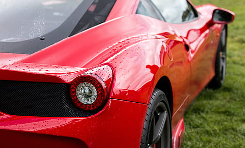 red Ferrari 458 Italia coupe on green field thumbnail